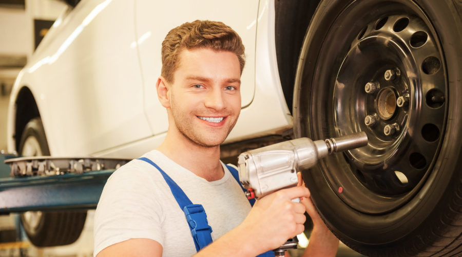 Removing tires from car.